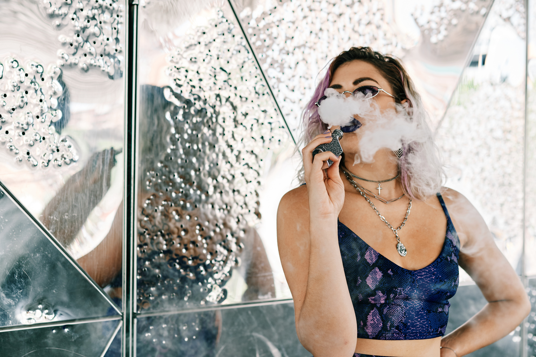 Young Hipster Girl Using a Vape